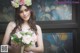 A woman in a wedding dress holding a bouquet of flowers.