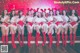 a group of women dressed in santa claus outfits posing for a photo