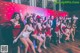 A group of women dressed in santa claus outfits posing for a photo.