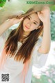 A woman with long brown hair is posing for a magazine cover.