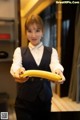 A woman holding a banana in her hands.