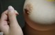 A close up of a person's hand touching a breast.