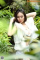 A woman in a white top and white shorts posing for a picture.