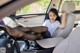 A woman sitting in the driver's seat of a car.