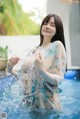 A woman in a blue and white kimono standing in a pool.