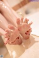 A close up of a woman's feet in a bathtub.